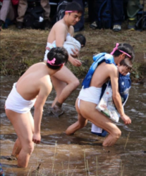 Naked, mud covered festivalgoers
