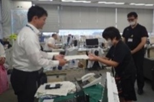 作った文書を課長に見せる子どもの写真