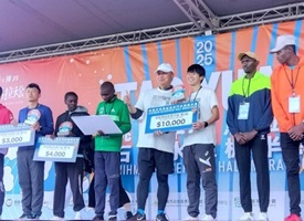 2025桃園ハーフマラソンの表彰式、ランナーが舞台で賞金等を受け取っている写真