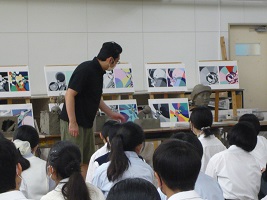 教員が生徒の陶芸作品を講評している画像