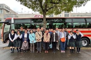 バスの前で参加者全員が記念撮影をしている写真