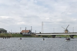 鹿島川での練習風景、背景には佐倉ふるさと公園の風車が見える