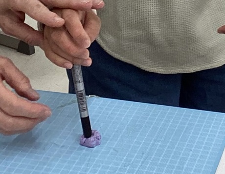 生徒が紙粘土を型取りしている様子