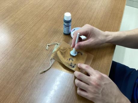 生徒が脱臭剤の袋を作成している様子