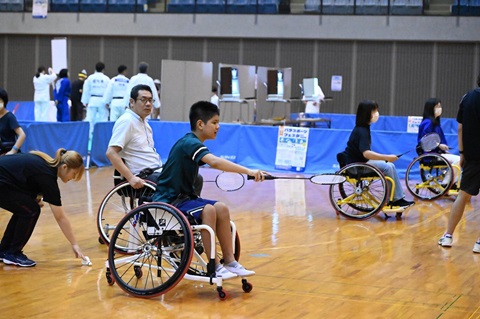 千葉ポートアリーナで車椅子に座りながらパラバドミントンを体験する男性
